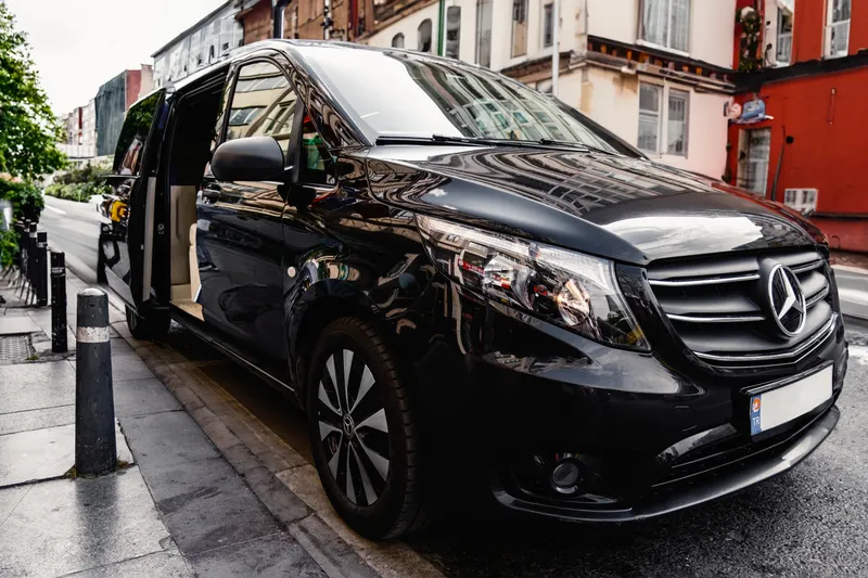 Illustrative black passenger van; not a TRAVABO-owned vehicle